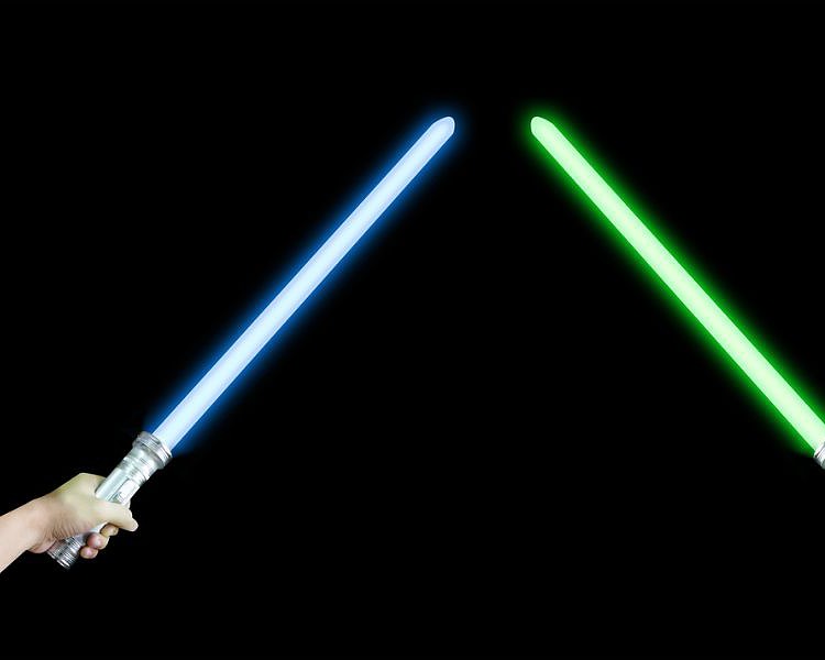a blue and green lightsaber held by two hands