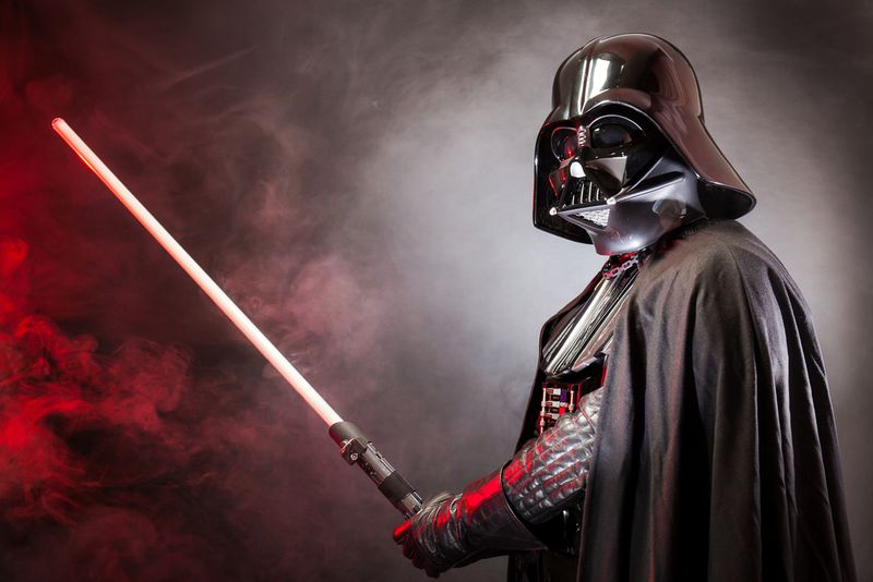 Darth Vader with a red lightsaber in black background