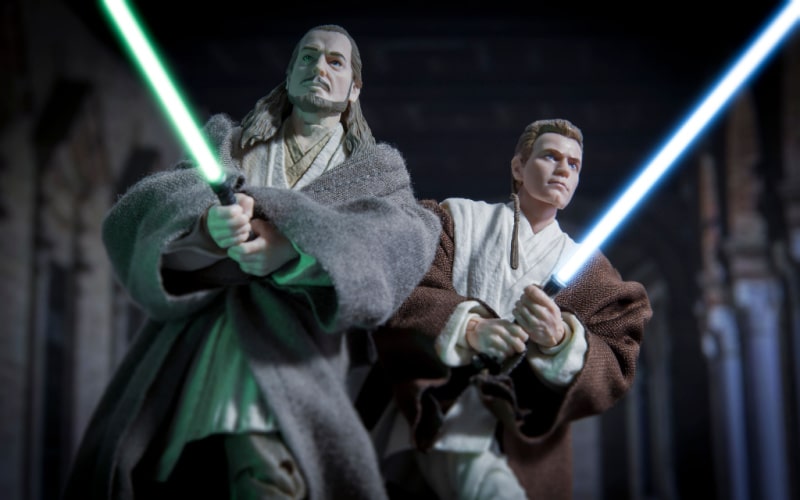 Jedi Masters Obi Wan Kenobi and Qui Gon Jinn fight together with their lightsabers
