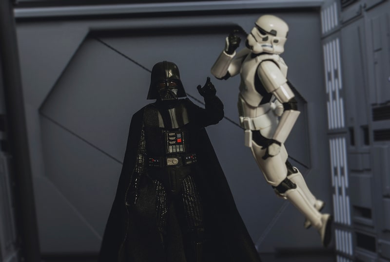 Star Wars Sith lord Darth Vader force choking a disobedient Stormtrooper