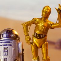 droids C-3PO and R2D2 on the desert planet of Tatooine with escape pod