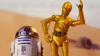 droids C-3PO and R2D2 on the desert planet of Tatooine with escape pod