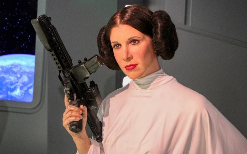 Princess Leia holds the blaster
