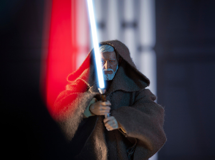 old Obi-Wan Kenobi and his blue lightsaber
