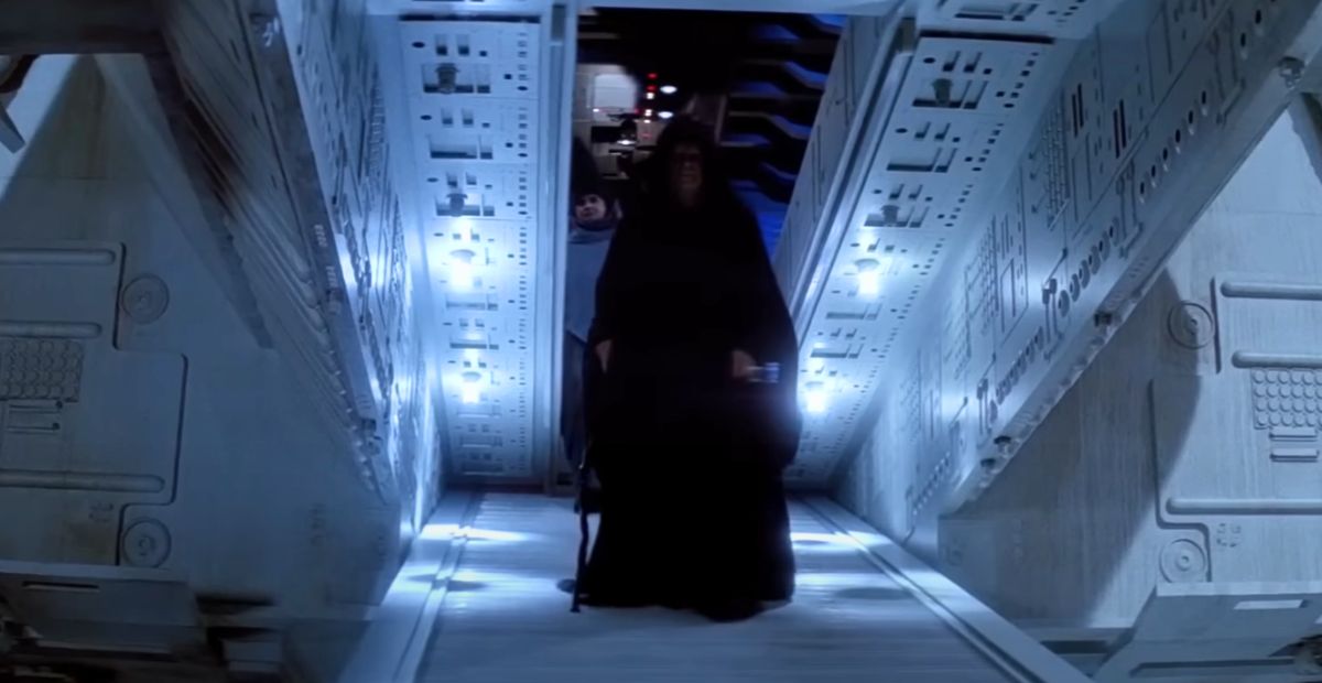 I Was Watching Episode VI Again When I Noticed This. Who Is That Person Behind the Emperor?