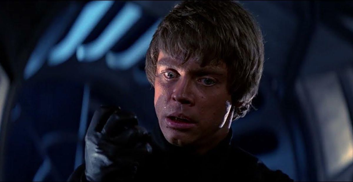 In ROTJ, After Defeating Vader, Why Did Luke Look at His Robotic Hand and Then Vader’s Robotic Arm, Before Throwing Away the Saber?