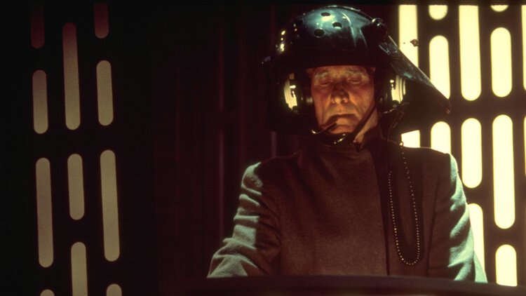 Black-uniformed Death Star troopers at their stations