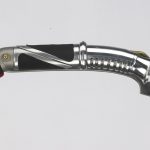 Dooku holds his curved-hilt red lightsaber