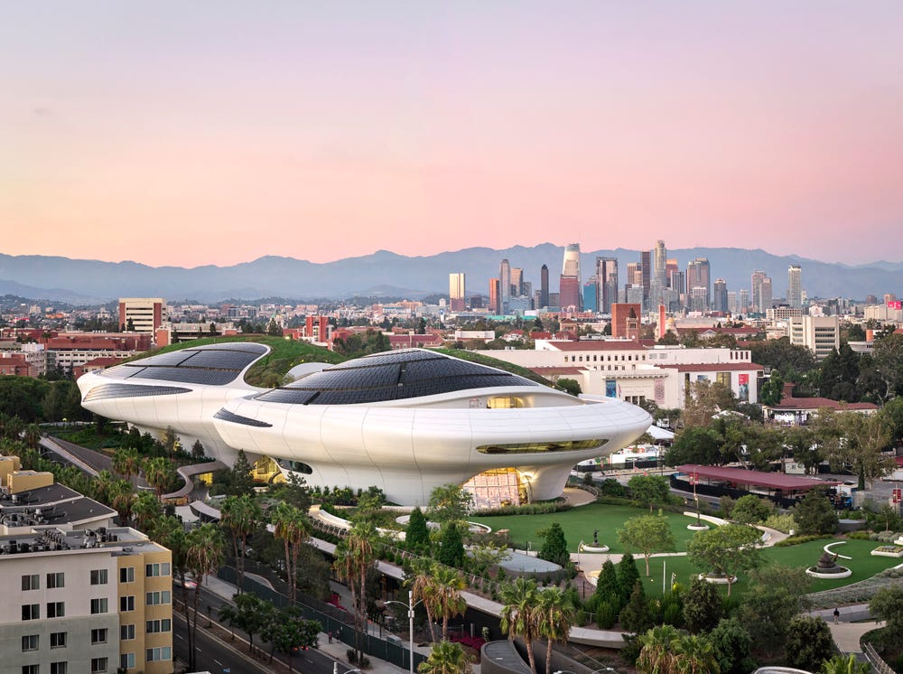 Lucas Museum of Narrative Art in Exposition Park with the Los Angeles skyline behind it