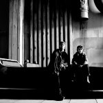 Ryan Gosling and Flynn Gray beside a vehicle on the Star Wars: Starfighter set.