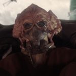 Plo Koon seated in a starfighter cockpit, wearing his breathing mask.