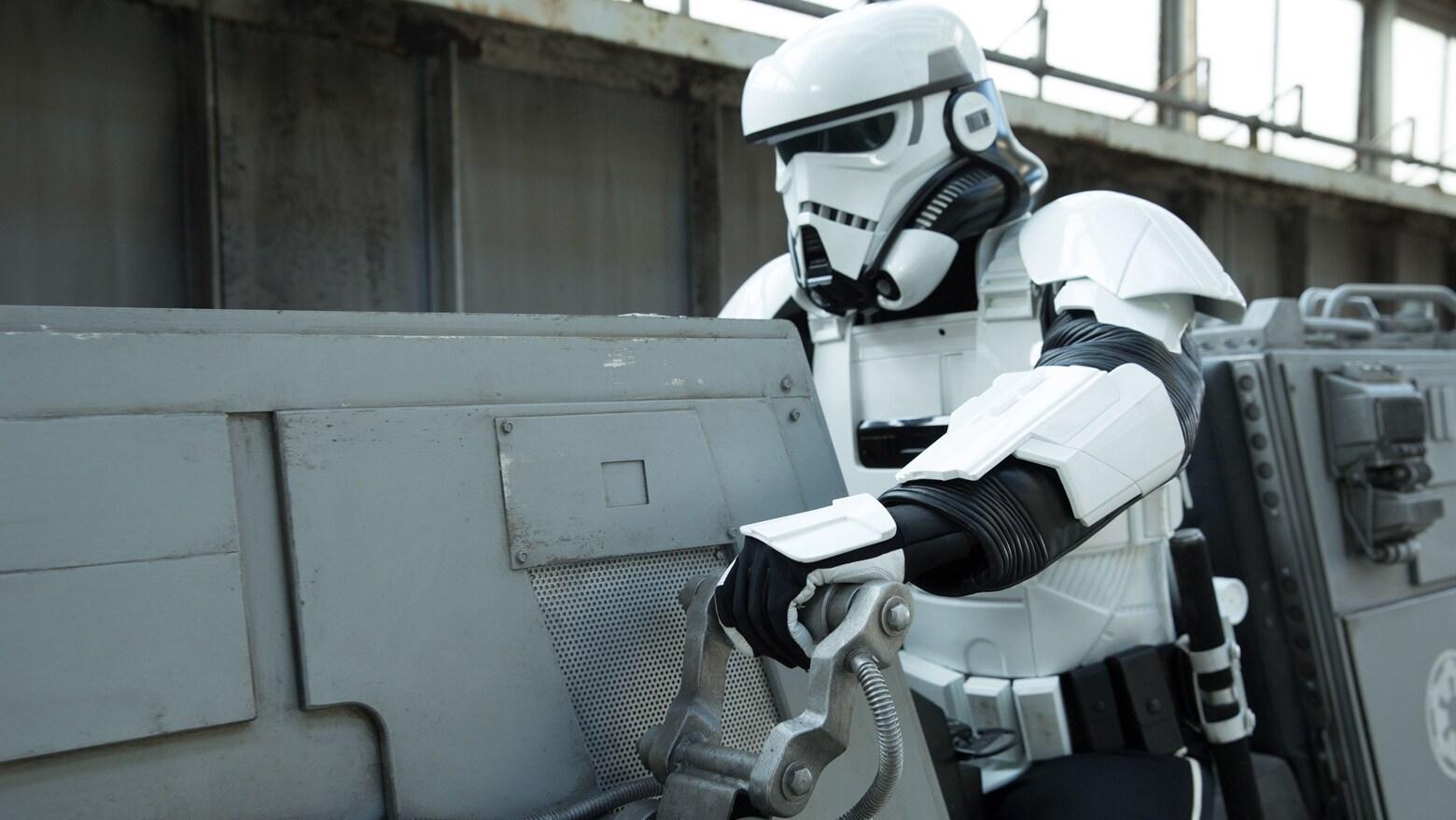 An Imperial patrol trooper beside a speeder on Corellia